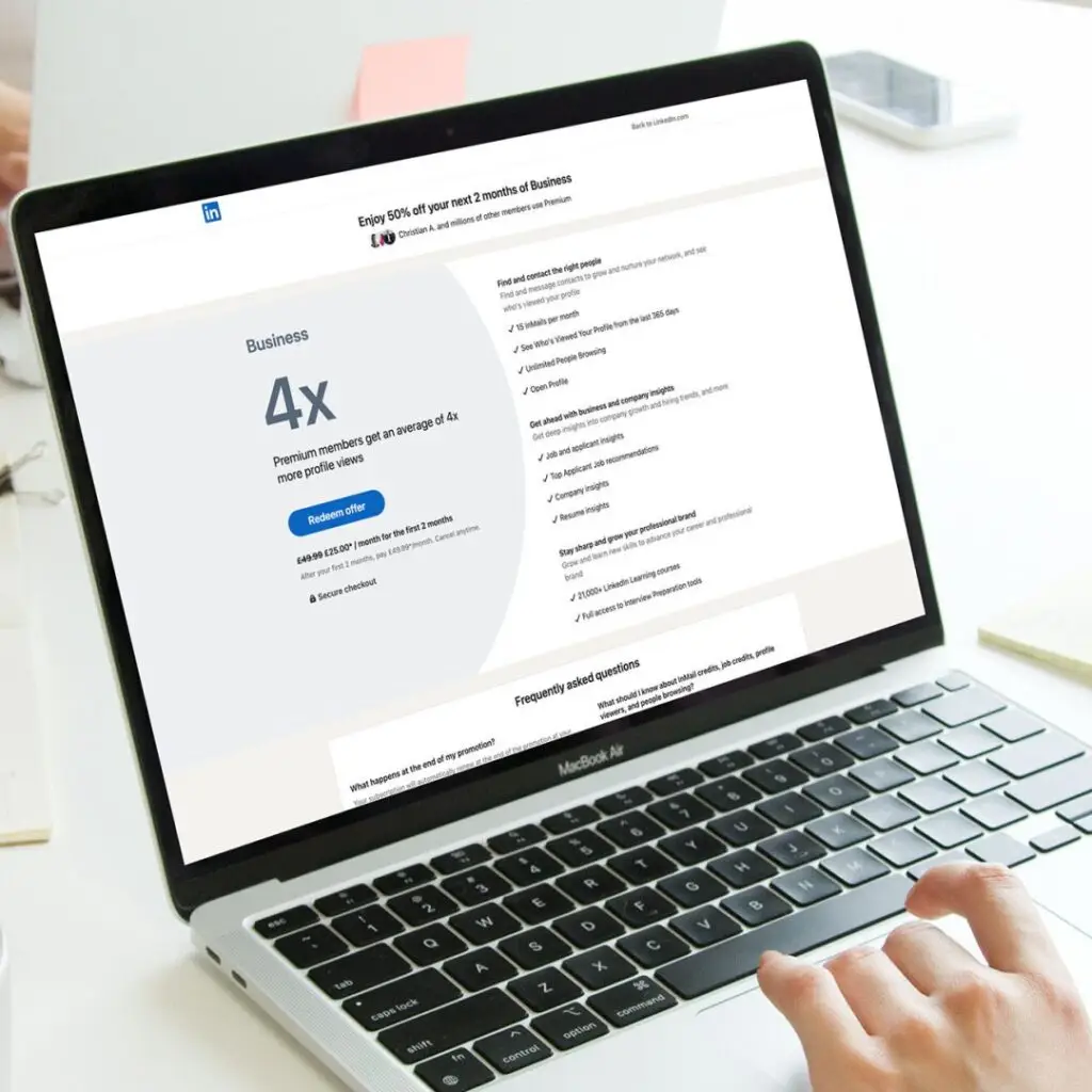 Person using laptop viewing LinkedIn Ads page with marketing performance metrics